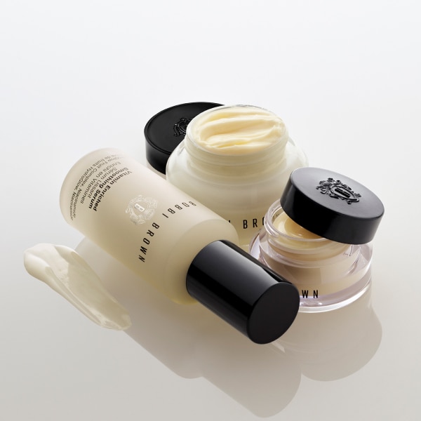 Model applying Skin Long-Wear Weightless Foundation to skin with a foundation brush