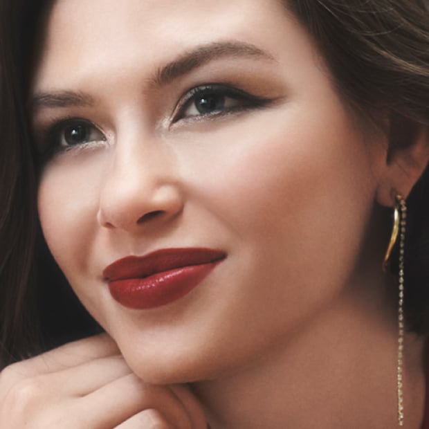 Close up of model eye showcasing defined brows and a natural, shimmery eye look