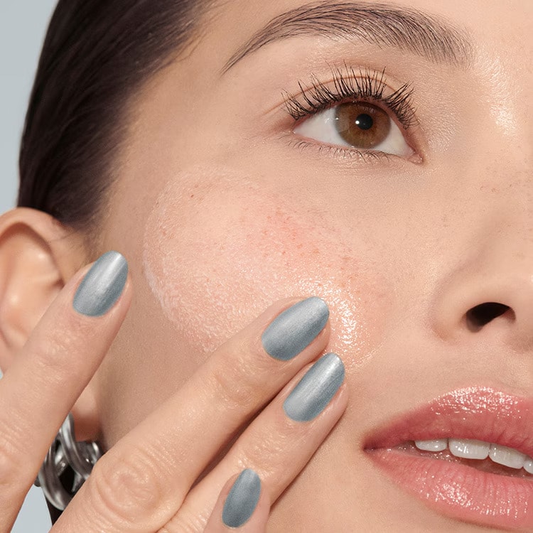 Model removing makeup with our gentle yet powerful Soothing Cleansing Oil